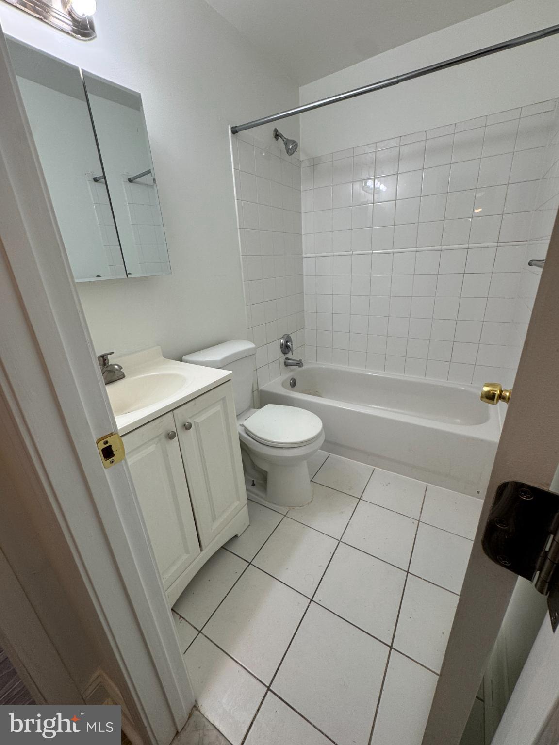 4110 Ames Street Northeast, Unit 14 Washington, DC 20019 - Photo 6 of 7 a bathroom with a sink a toilet and shower