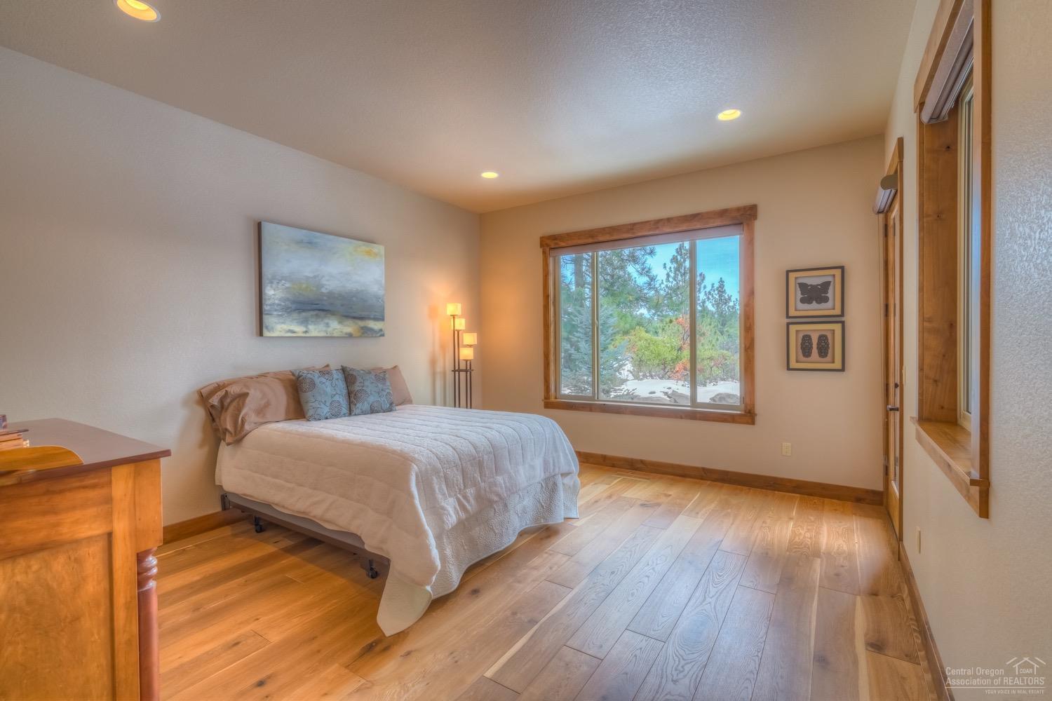 60436 Snap Shot Loop Bend, OR 97702 - Photo 11 of 25 Downstairs master suite with hardwood fl