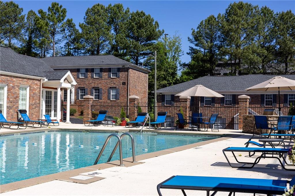 4883 Roswell Road, Unit N1 Atlanta, GA 30342 - Photo 14 of 15 a patio with hardwood table and chairs