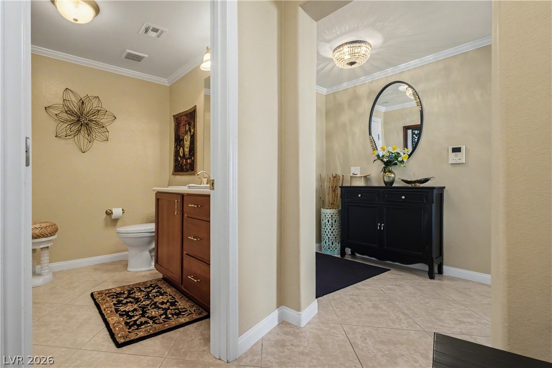 2555 Hampton Road, Unit 3308 Henderson, NV 89052 - Photo 26 of 65 A well-appointed powder room features a vanity with rich wood cabinetry and a functional toilet area.