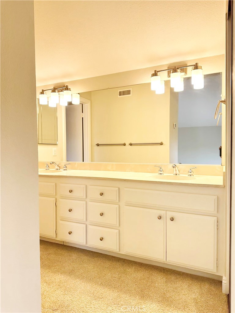23 Whistling Swan Irvine, CA 92604 - Photo 12 of 26 a bathroom with a sink mirror and
