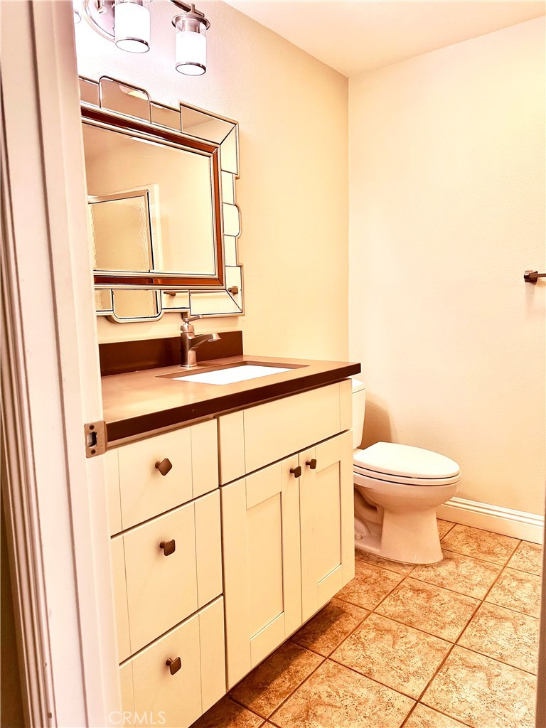 23 Whistling Swan Irvine, CA 92604 - Photo 3 of 26 a bathroom with a sink a toilet and mirror