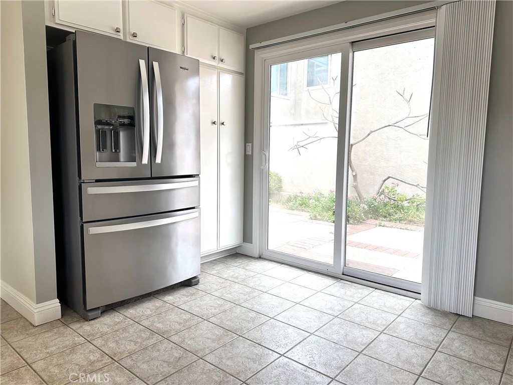 23 Whistling Swan Irvine, CA 92604 - Photo 8 of 26 a kitchen with a refrigerator and white cabinets