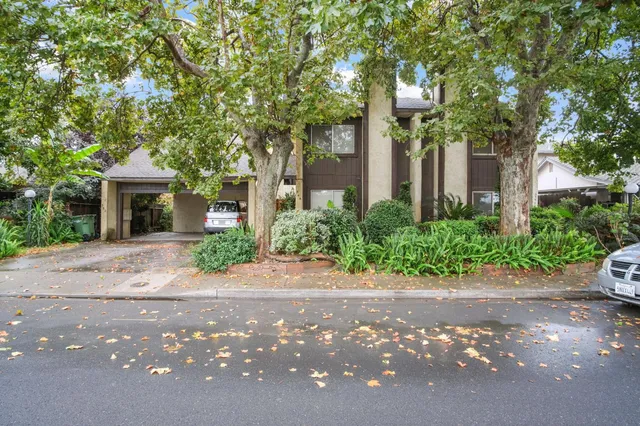 a front view of a house with a garden