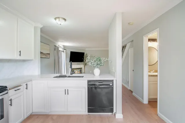 a kitchen with cabinets and stainless steel appliances