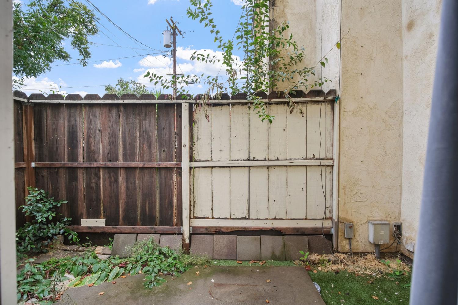 348 Wayside Drive Turlock, CA 95380 - Photo 21 of 22 a wooden fence covered with tall trees