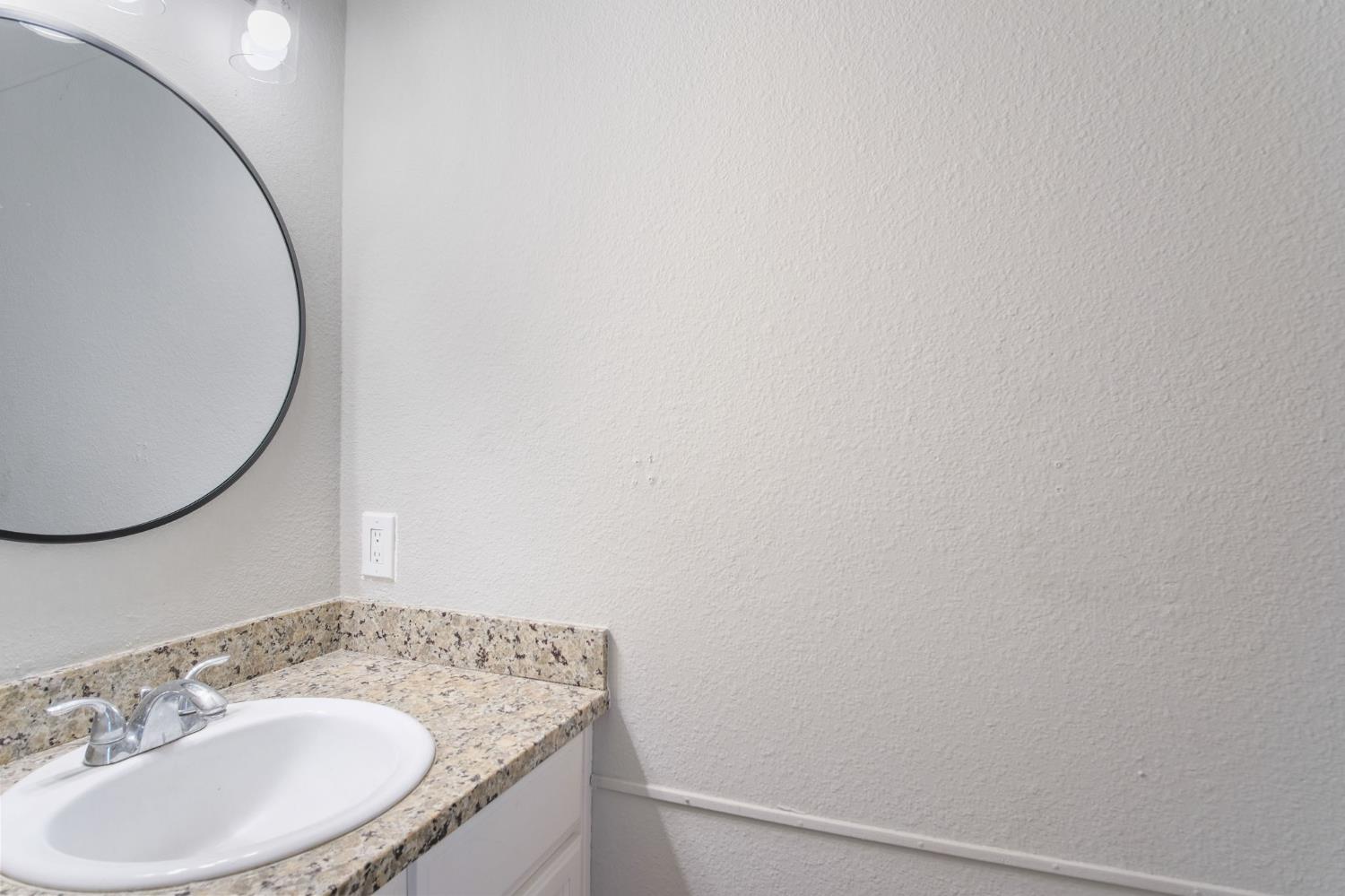 348 Wayside Drive Turlock, CA 95380 - Photo 8 of 22 a bathroom with a sink and a mirror