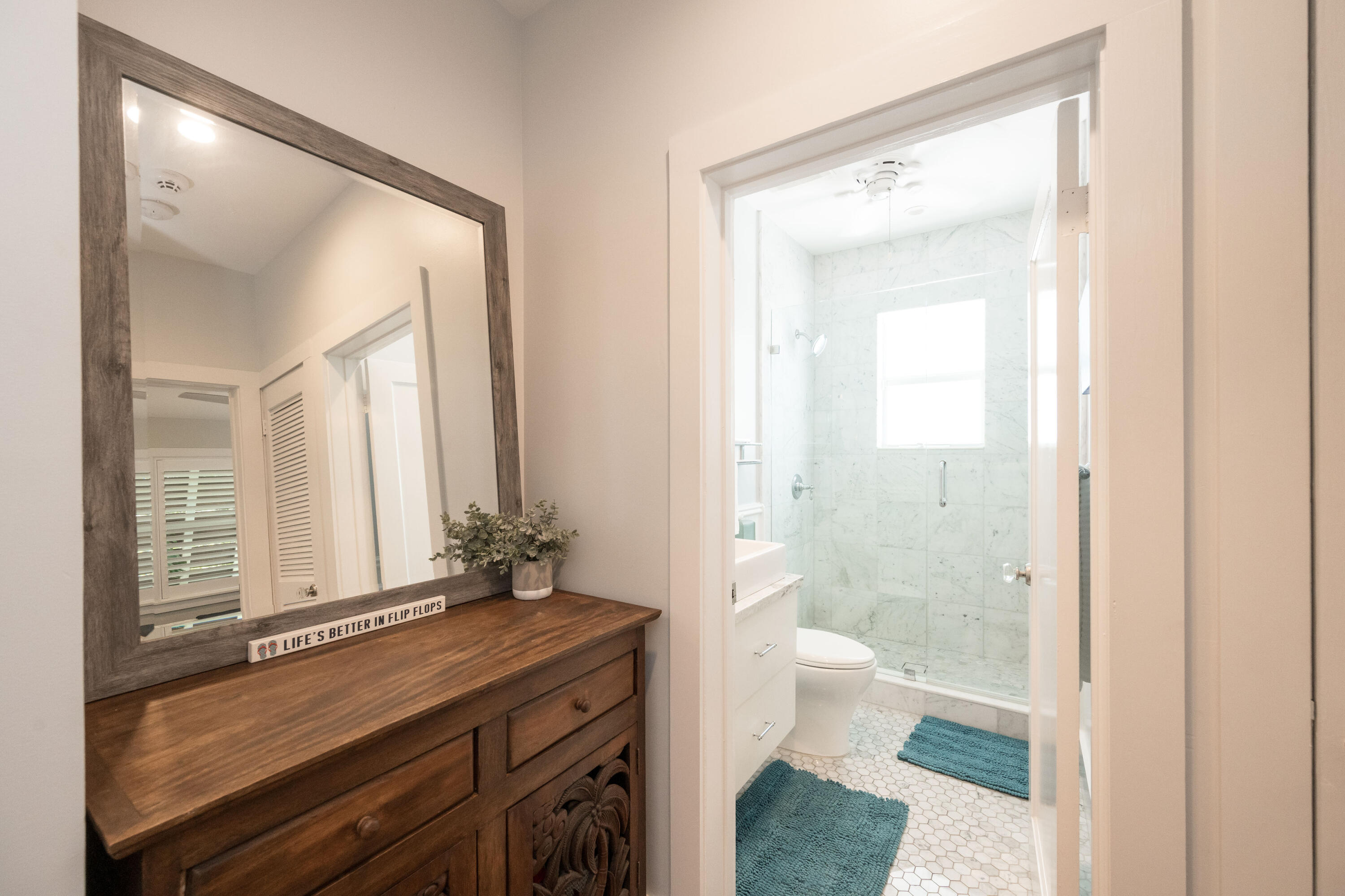1231 Washington Street Key West, FL 33040 - Photo 22 of 41 a view of bathroom with a toilet sink and a mirror