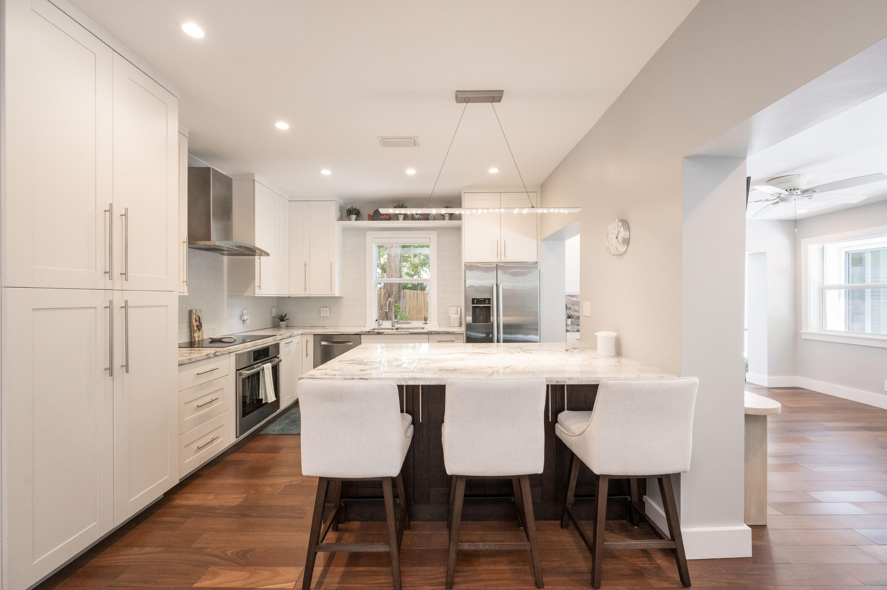 1231 Washington Street Key West, FL 33040 - Photo 25 of 41 a large kitchen with kitchen island a table and chairs in it