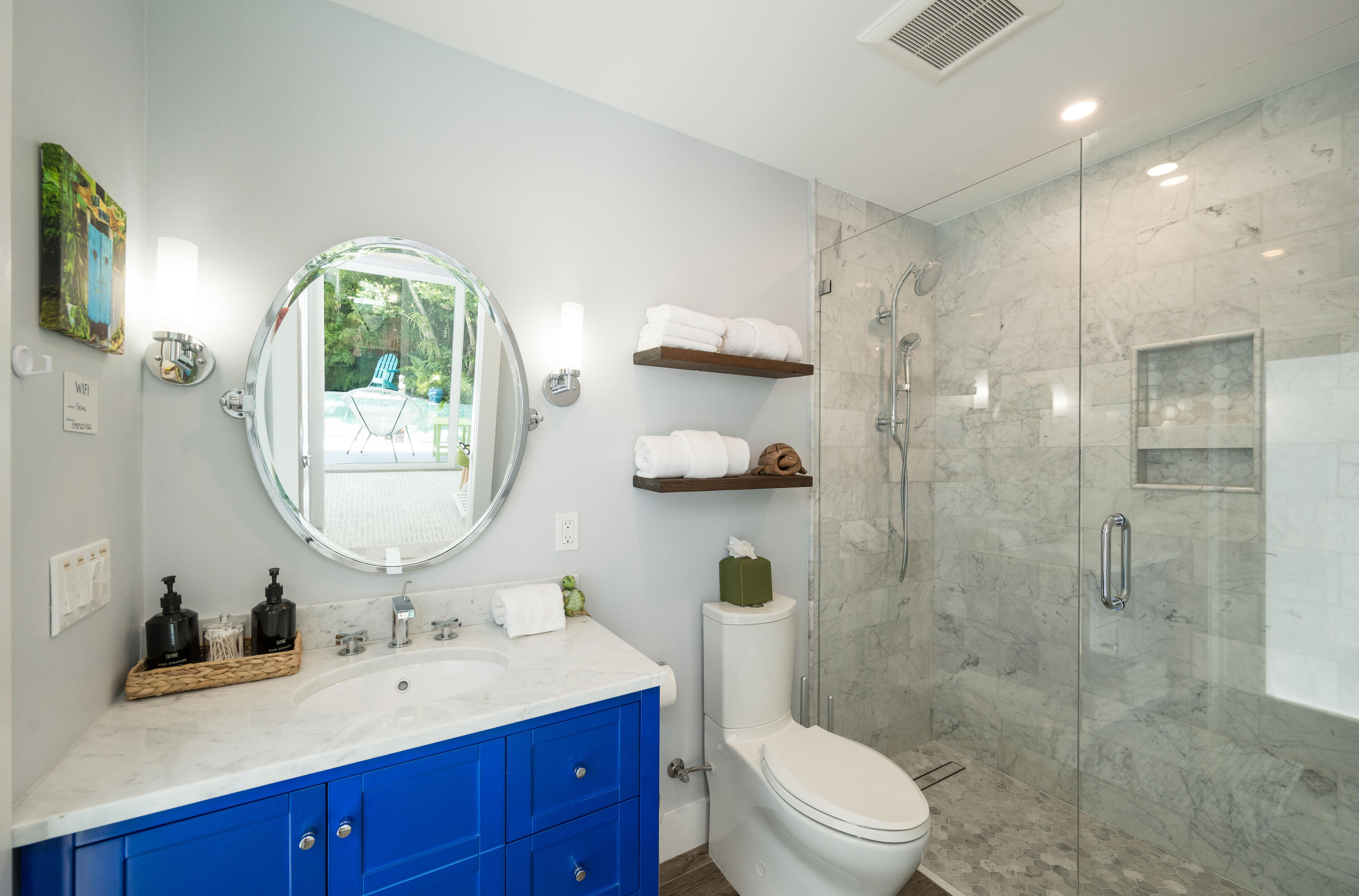 1231 Washington Street Key West, FL 33040 - Photo 37 of 41 a bathroom with a toilet a sink a glass door a shower and vanity