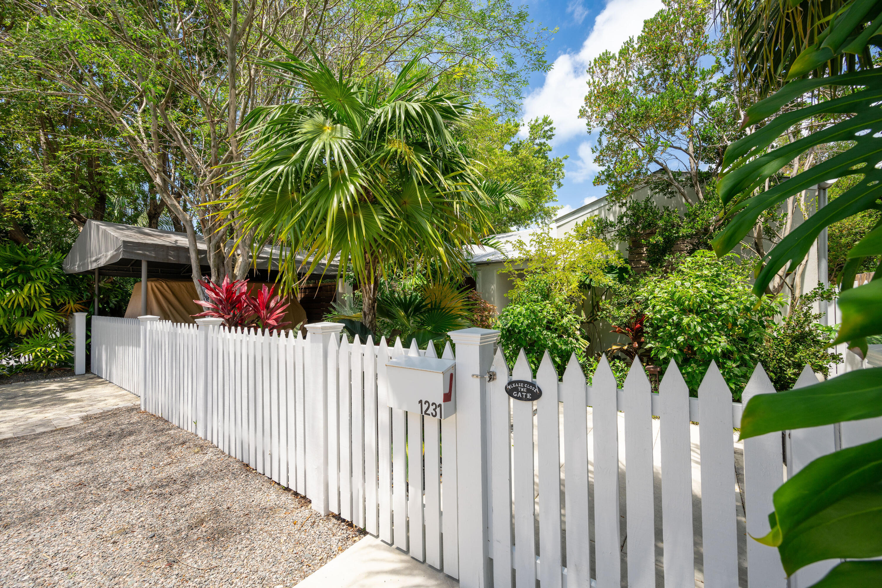 1231 Washington Street Key West, FL 33040 - Photo 7 of 41 a yard with yellow house in front of it