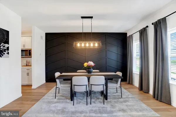 a view of a dining room with furniture and chandelier