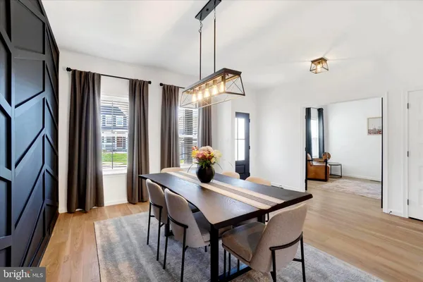a view of a dining room with furniture window and wooden floor