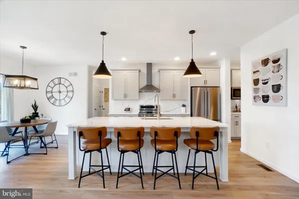 a dining table chairs and a chandelier