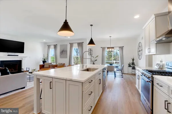 a kitchen with sink stove and cabinets