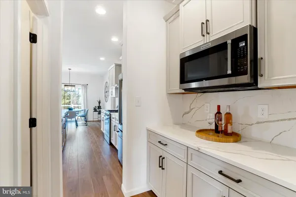 a kitchen with stainless steel appliances a stove a microwave and sink