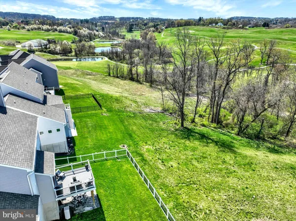 an aerial view of lake residential houses with outdoor space and trees