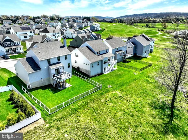 an aerial view of multiple houses with yard