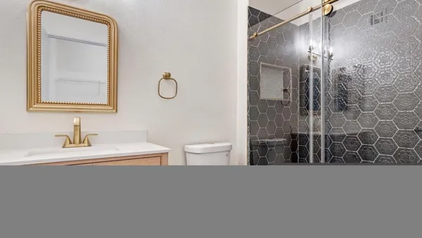 a bathroom with a toilet a sink and mirror