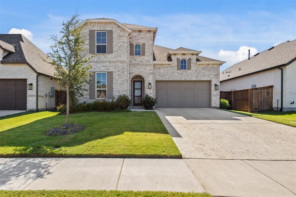 1825 Rough Rdg Trail Midlothian, TX 76065 - Photo 2 of 37 Stone veneer facade with arched entry, two-car garage, and established front landscaping