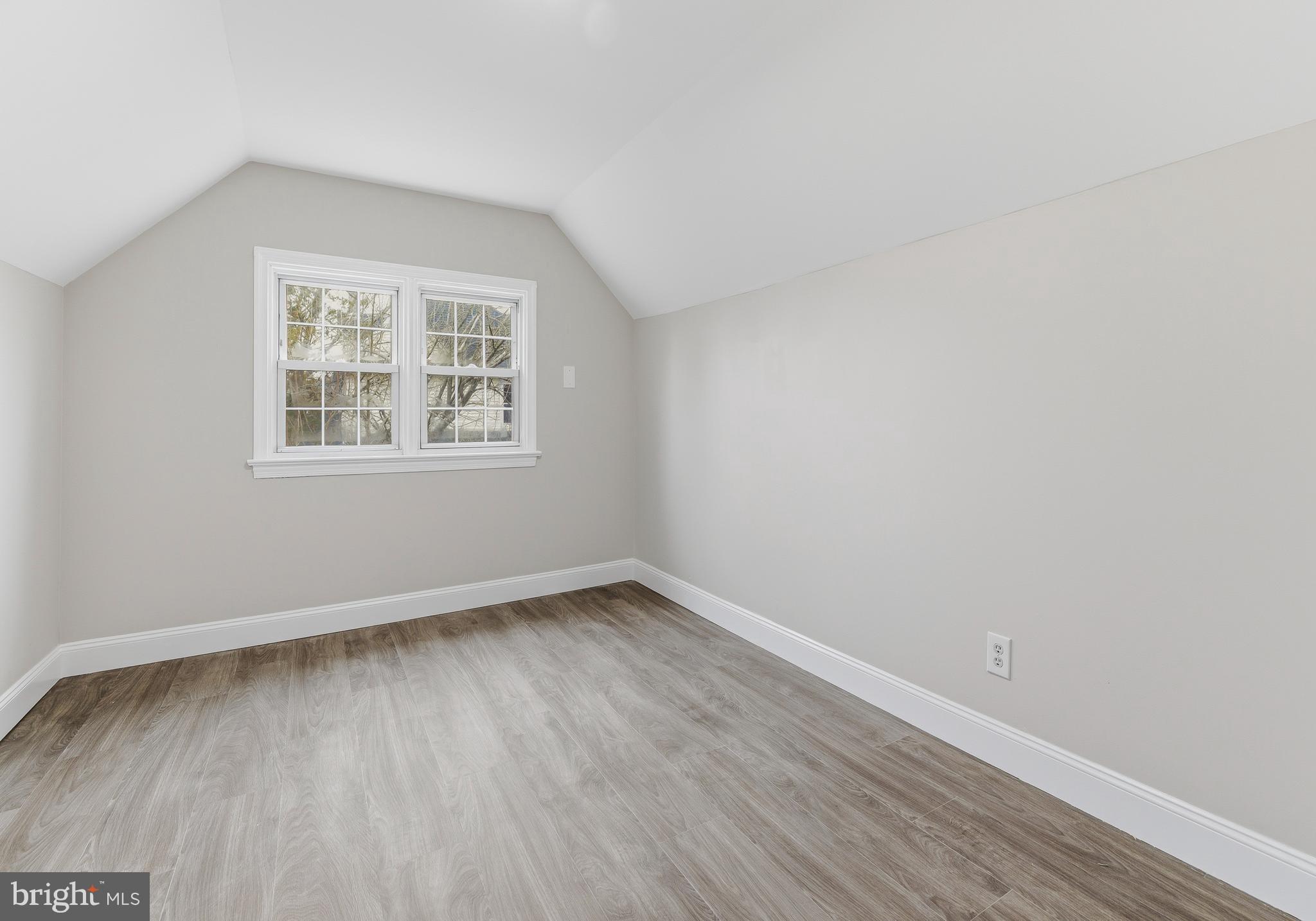 127 Madison Avenue Laurel Springs, NJ 08021 - Photo 14 of 22 an empty room with wooden floor and windows