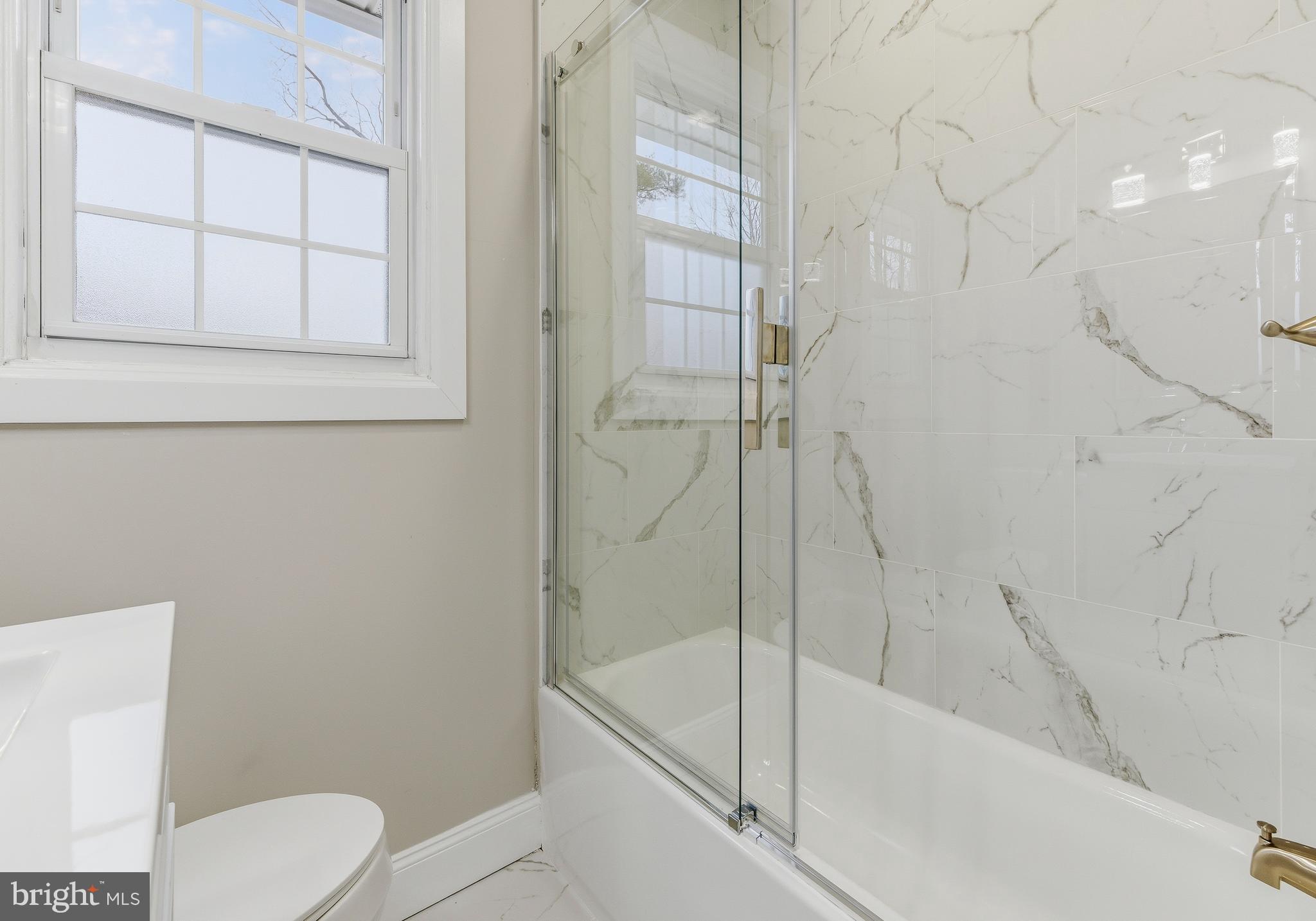 127 Madison Avenue Laurel Springs, NJ 08021 - Photo 16 of 22 a bath room with a toilet and a bath tub