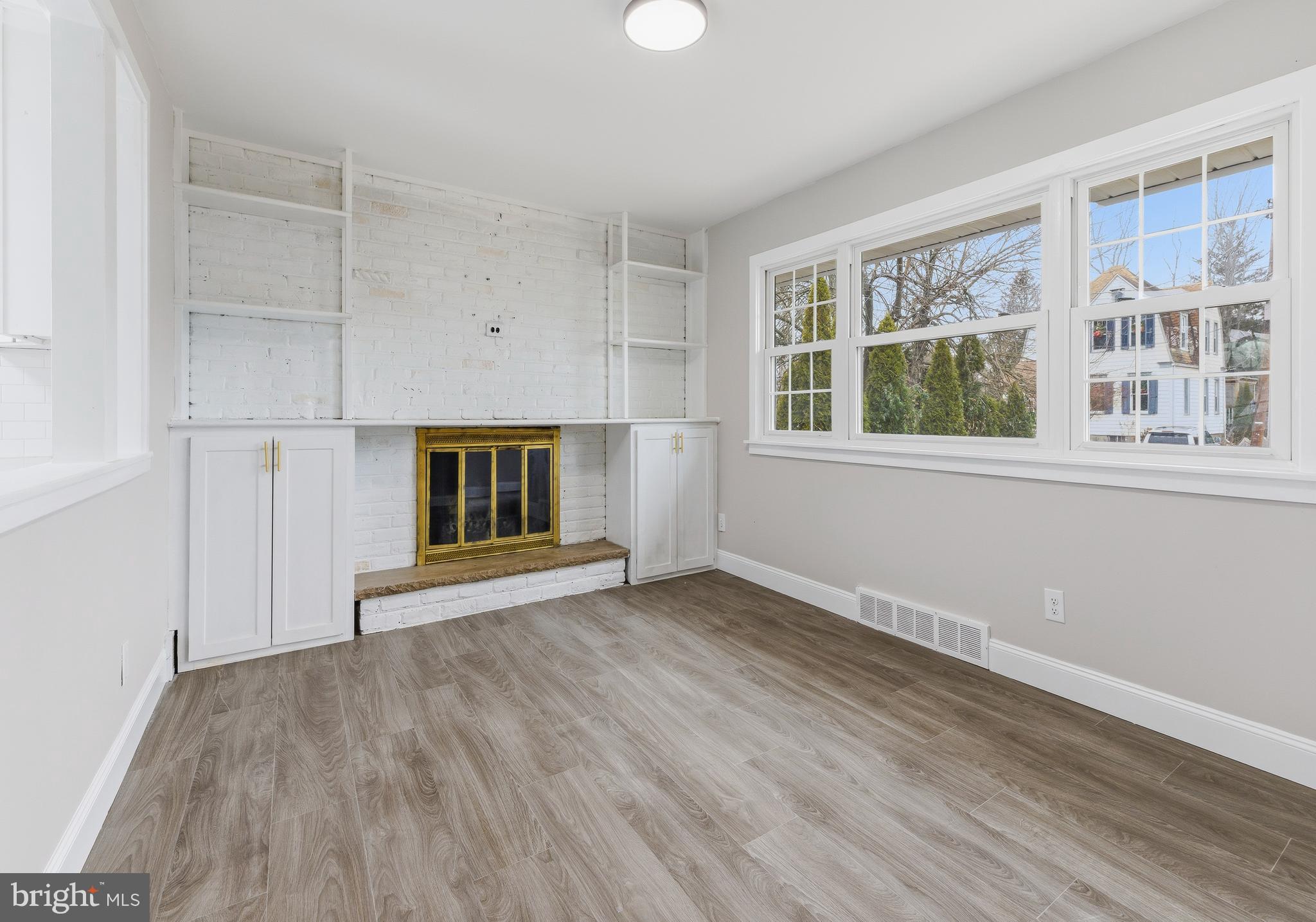 127 Madison Avenue Laurel Springs, NJ 08021 - Photo 4 of 22 a view of an empty room with wooden floor and a window