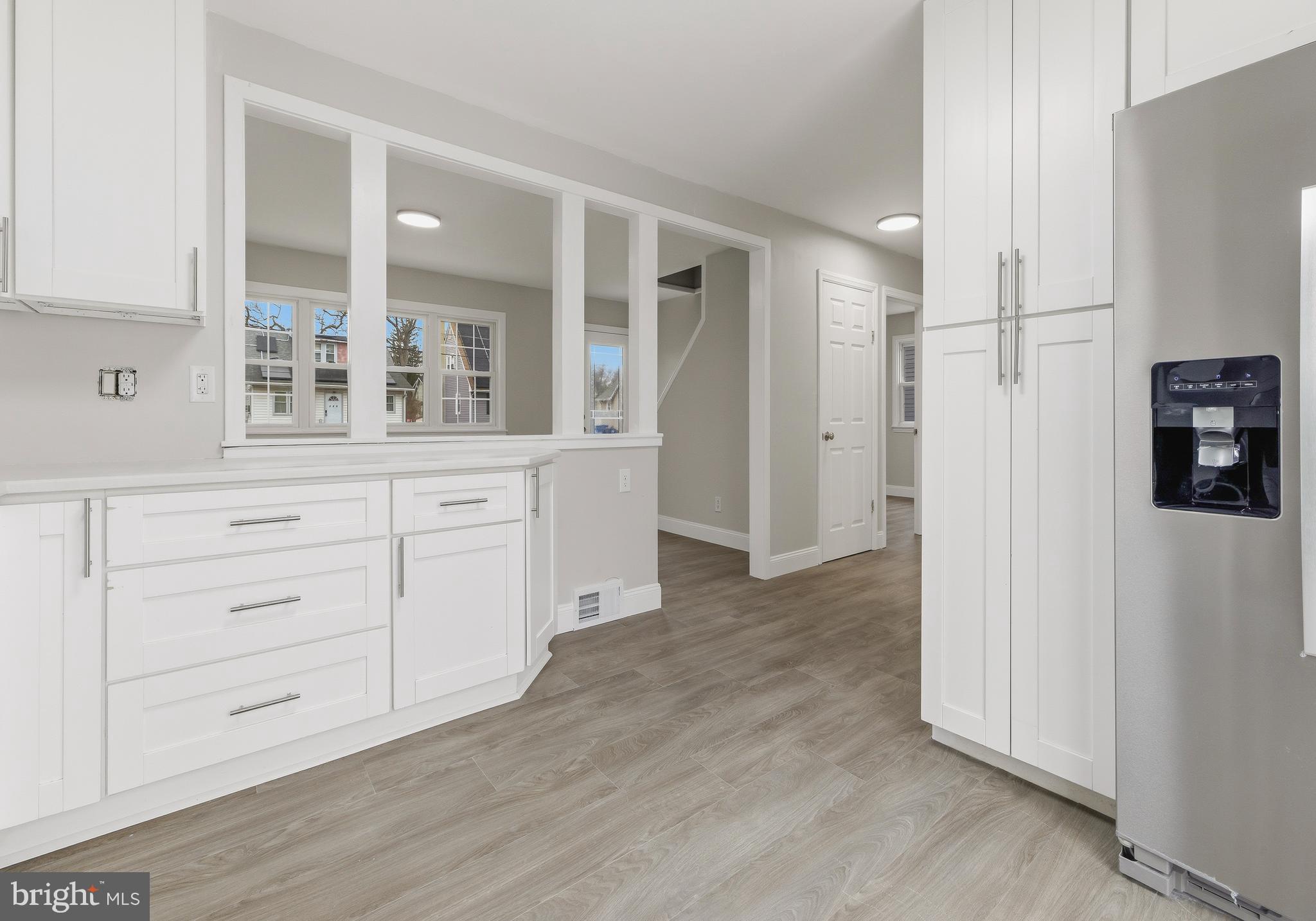 127 Madison Avenue Laurel Springs, NJ 08021 - Photo 5 of 22 a view of kitchen with wooden floor and cabinets