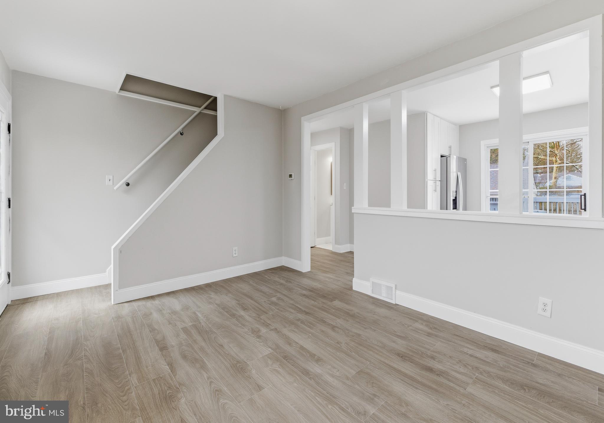 127 Madison Avenue Laurel Springs, NJ 08021 - Photo 7 of 22 an empty room with wooden floor and windows