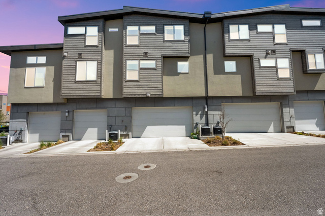 7713 Navarro View Court Midvale, UT 84047 - Photo 41 of 41 Modern multi-level townhome featuring a neutral stucco and horizontal siding facade