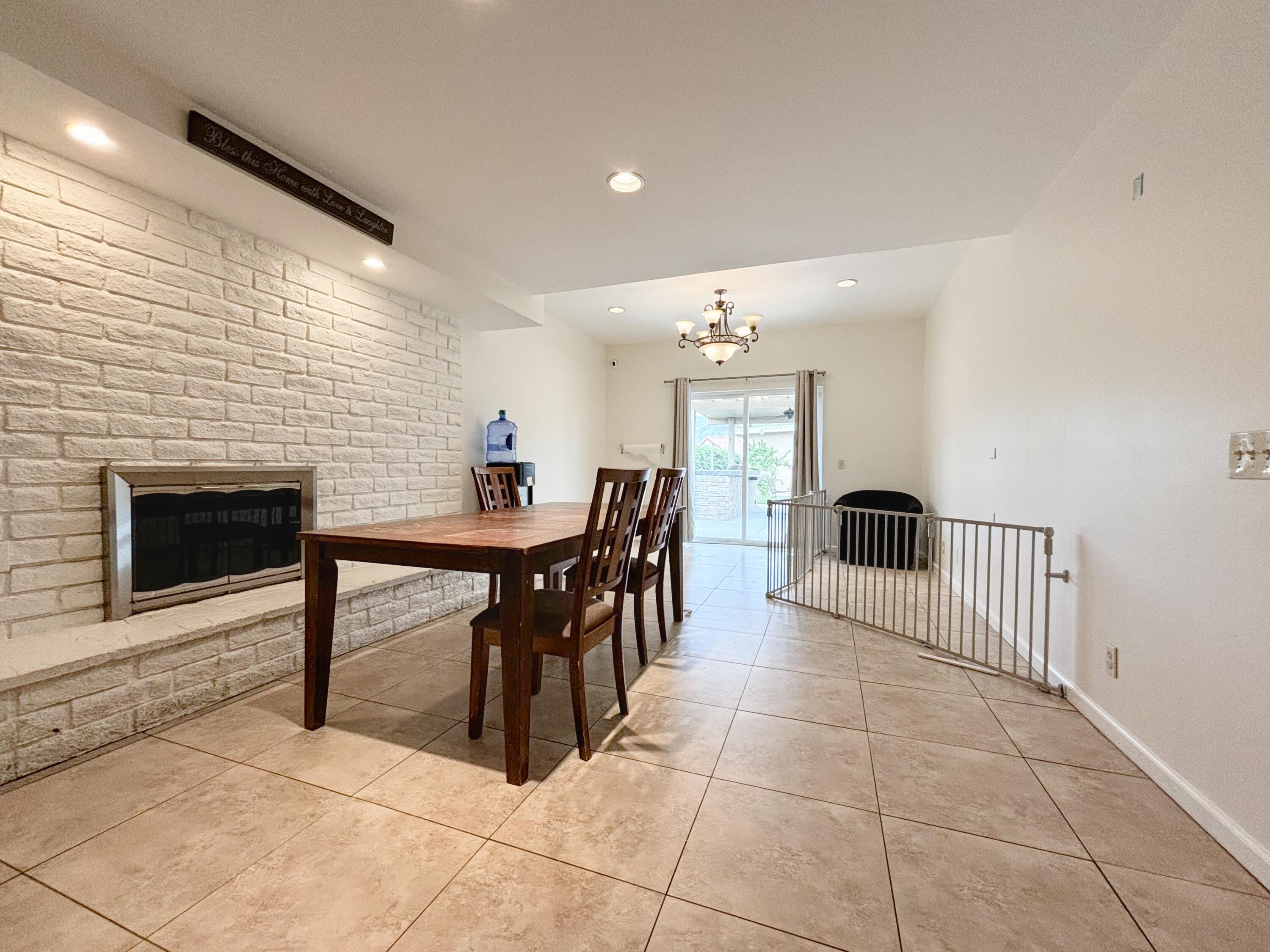 44755 Deep Canyon Road Palm Desert, CA 92260 - Photo 11 of 16 a dining room filled with furniture and a fireplace