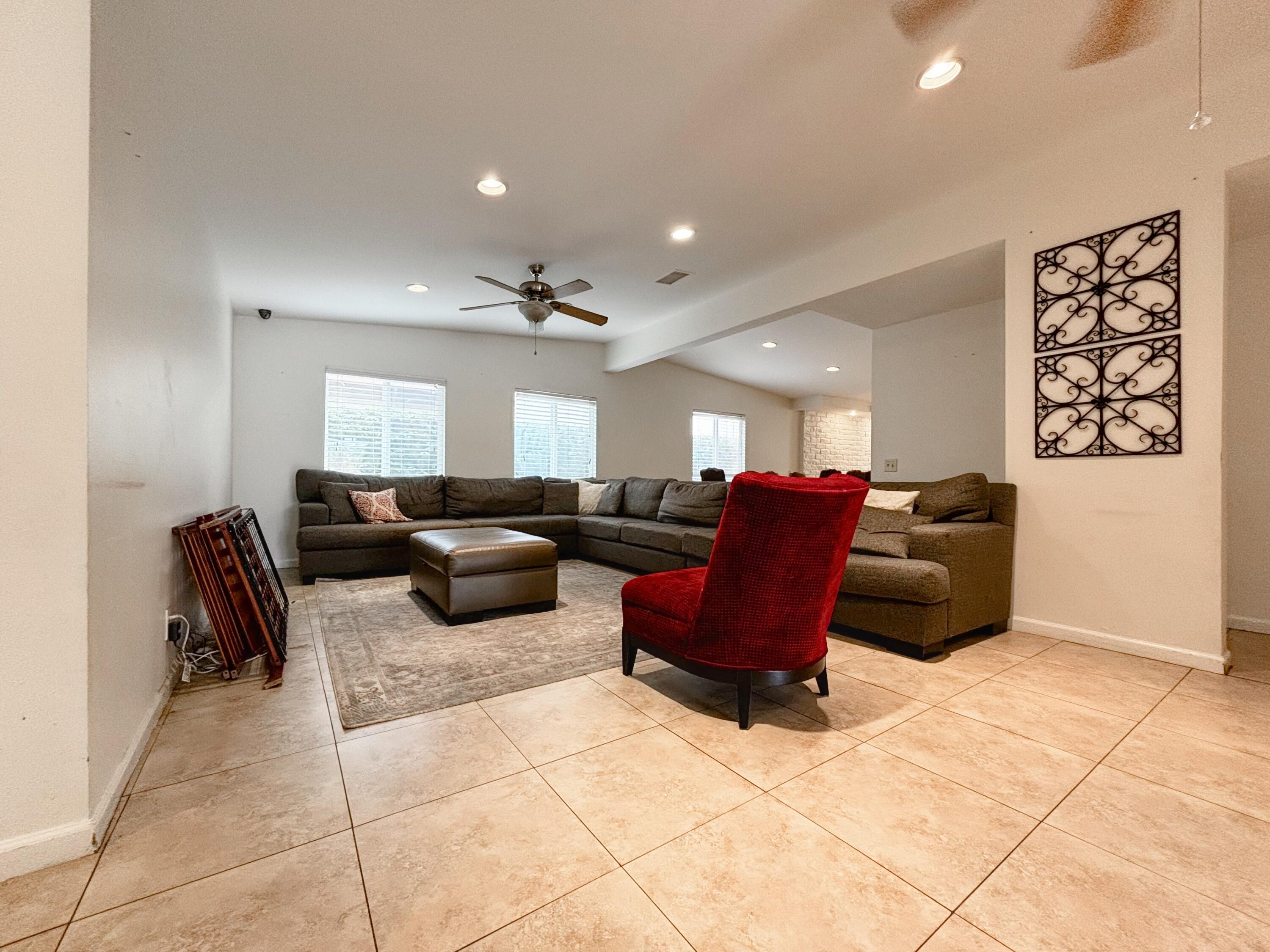 44755 Deep Canyon Road Palm Desert, CA 92260 - Photo 12 of 16 a living room with furniture a rug and a window