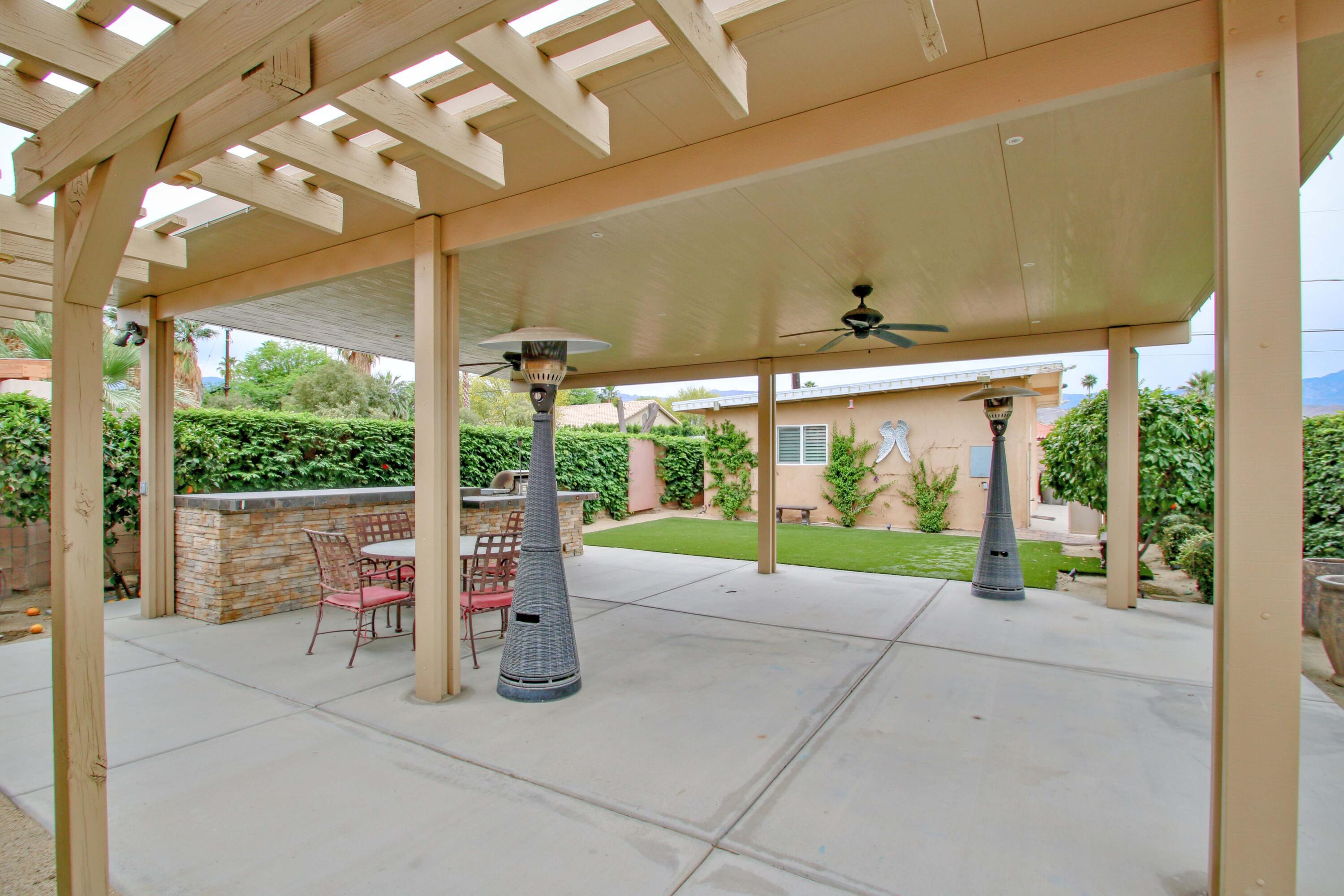 44755 Deep Canyon Road Palm Desert, CA 92260 - Photo 16 of 16 a view of a patio with a table and chairs in front of it
