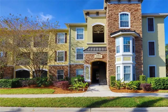 a front view of a house with yard and green space