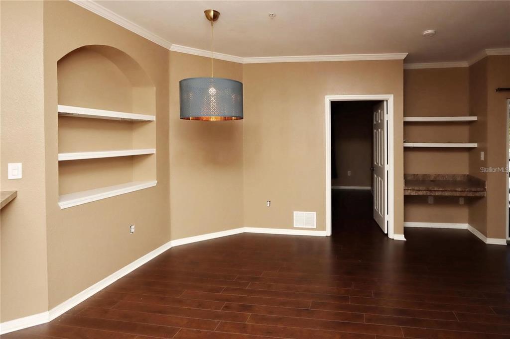 9918 Courtney Palms Boulevard, Unit 201 Tampa, FL 33619 - Photo 11 of 24 a view of a room with wooden floor