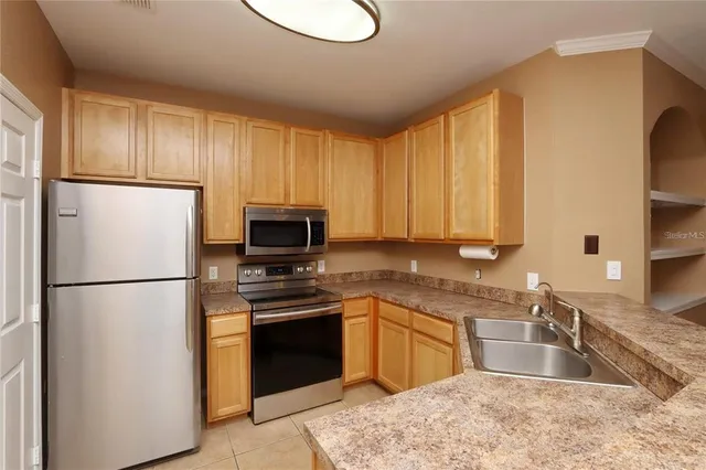 a kitchen with a refrigerator sink and microwave