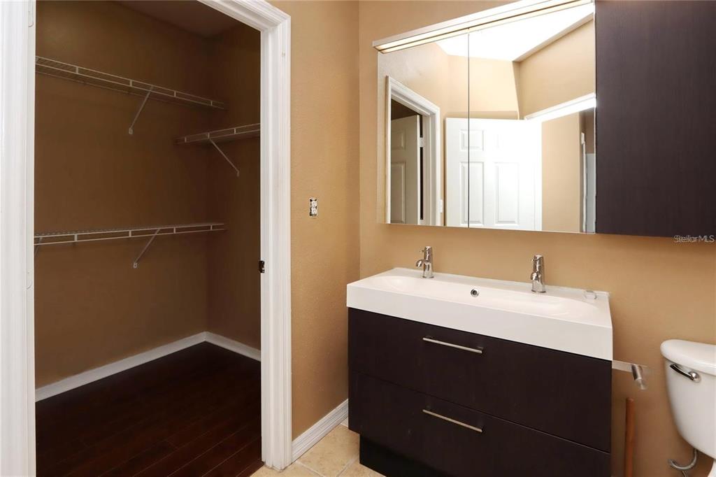 9918 Courtney Palms Boulevard, Unit 201 Tampa, FL 33619 - Photo 16 of 24 a bathroom with a sink and a mirror