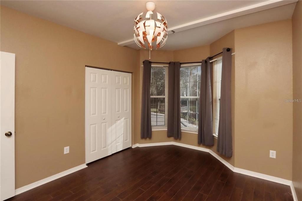 9918 Courtney Palms Boulevard, Unit 201 Tampa, FL 33619 - Photo 20 of 24 a view of empty room with wooden floor and fan