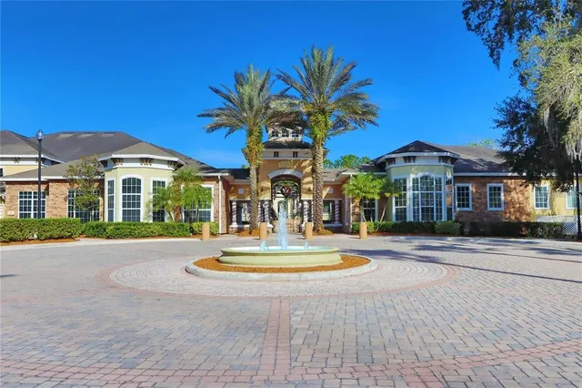 a front view of a house with swimming pool and porch