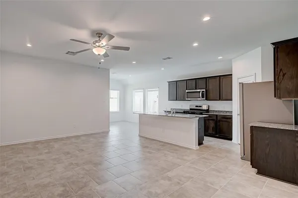 a large kitchen with cabinets and stainless steel appliances