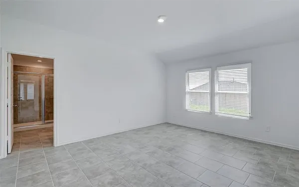 an empty room with windows and closet