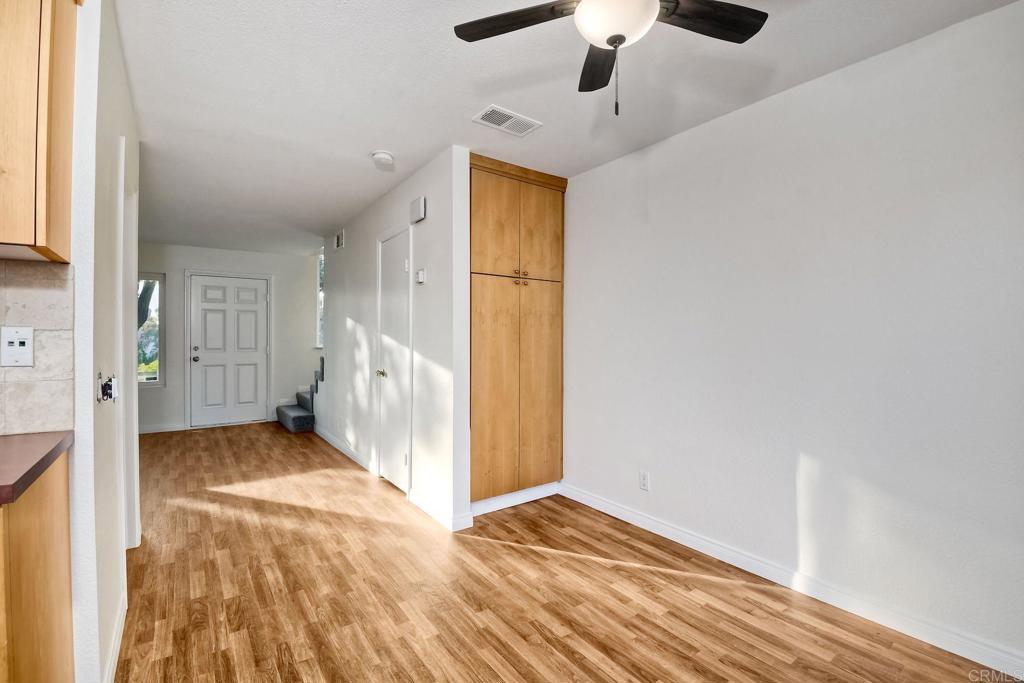 3605 Surfline Way Oceanside, CA 92056 - Photo 13 of 32 a view of a livingroom with wooden floor and a ceiling fan