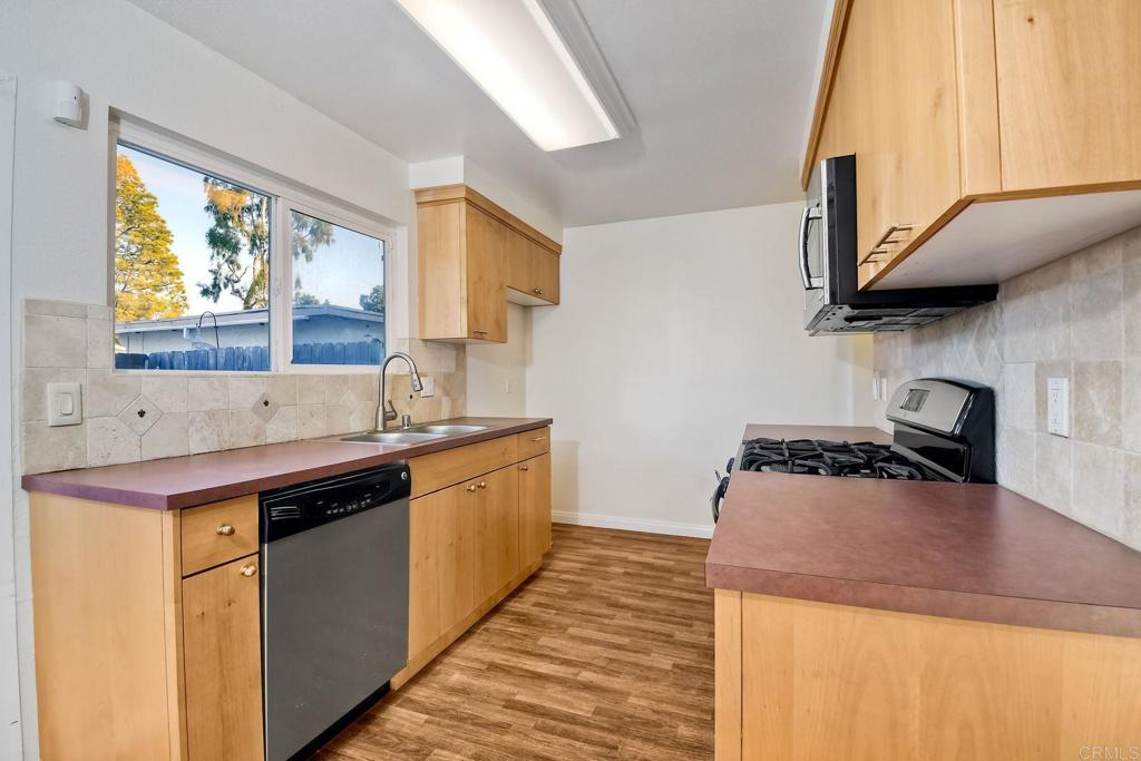 3605 Surfline Way Oceanside, CA 92056 - Photo 15 of 32 a kitchen with a sink and a stove