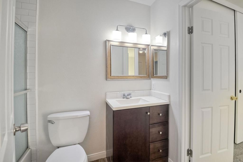 3605 Surfline Way Oceanside, CA 92056 - Photo 21 of 32 a bathroom with a toilet sink and mirror