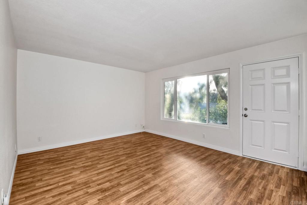 3605 Surfline Way Oceanside, CA 92056 - Photo 6 of 32 a view of an empty room with wooden floor and a window