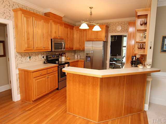 9404 Stone Mountain Road Raleigh, NC 27613 - Photo 22 of 25 Kitchen Features Beautiful Maple Cabinetry and Hardwood Flooring And Is Open to the Breakfast Room and Family Room Areas! Right Around The Corner Is the 2nd Staircase to the Bonus Room! Just An All Around Great Floorplan! Kitchen
