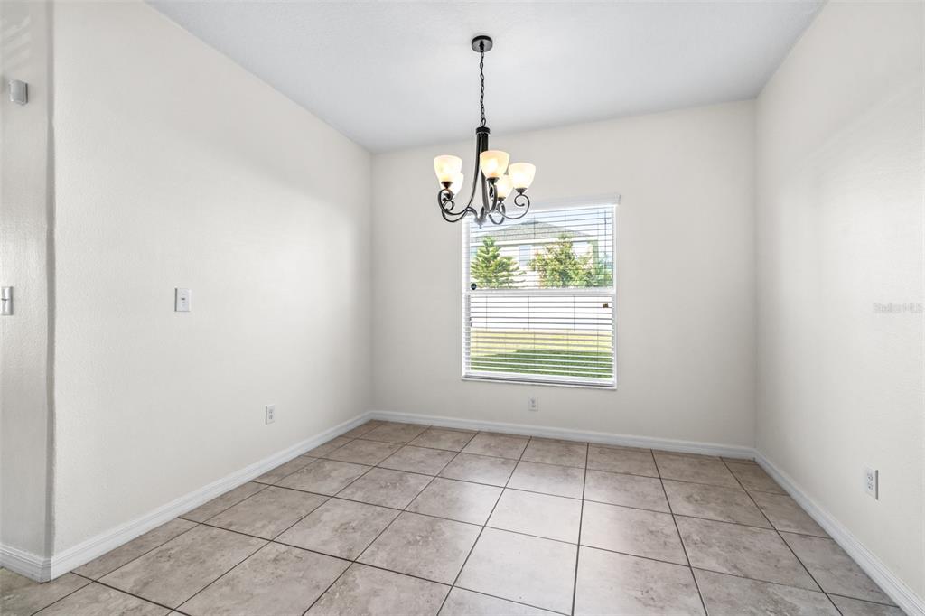 16713 Scenic Hill Way Wimauma, FL 33598 - Photo 15 of 52 a view of an empty room with a window
