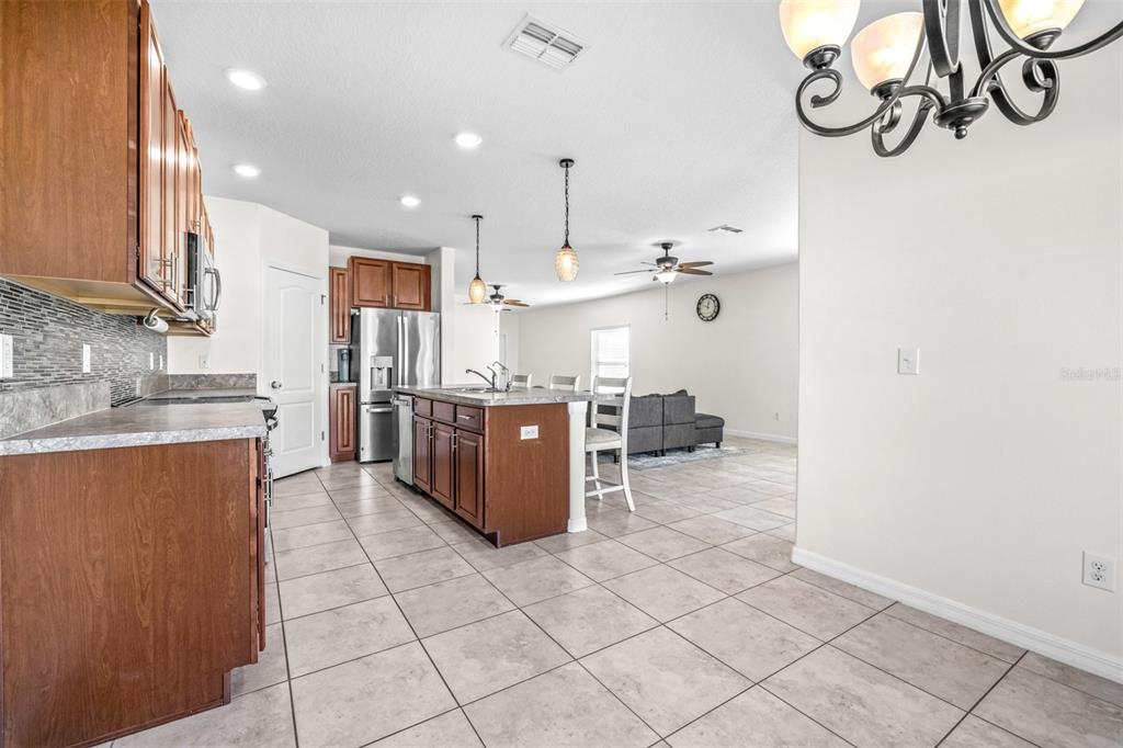 16713 Scenic Hill Way Wimauma, FL 33598 - Photo 16 of 52 a kitchen with stainless steel appliances granite countertop a sink and a cabinets