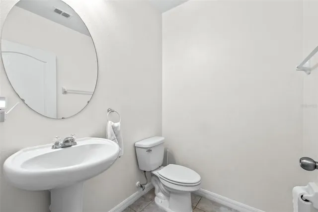 a bathroom with a sink a mirror and a toilet