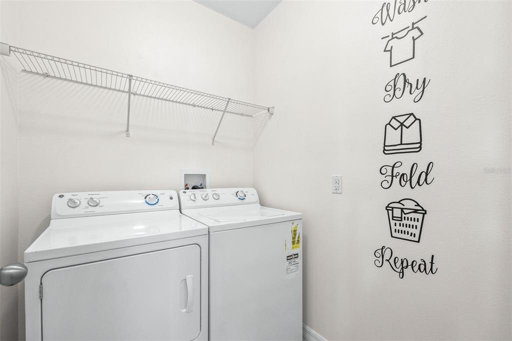 16713 Scenic Hill Way Wimauma, FL 33598 - Photo 19 of 52 a utility room with dryer and washer